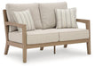 Hallow Creek Outdoor Loveseat with Cushion - De Avenue Furniture